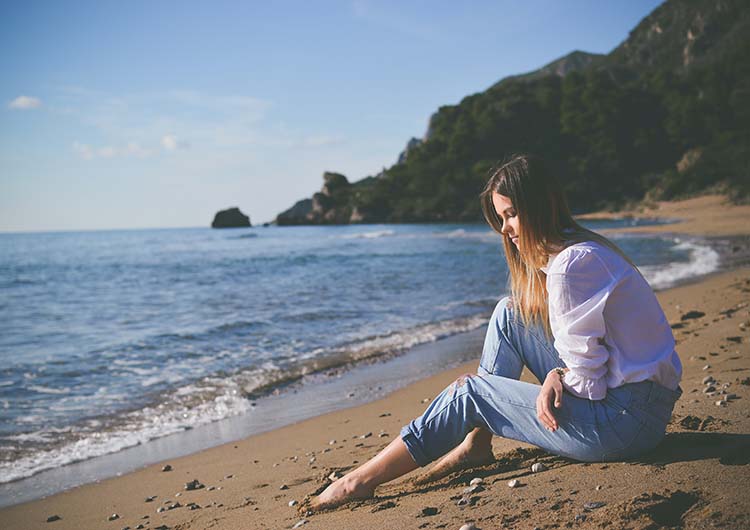 Girl sitting on the beach