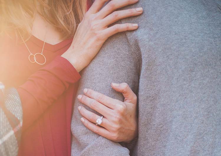 A woman holding a mans arm