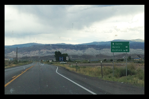 Sign for Salina, Aurora, and Richfield on side of road