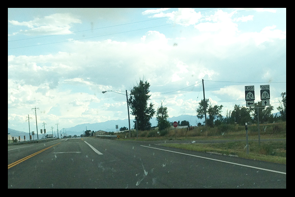 Signs for UT 24 and UT 118 on side of road at intersection