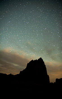 Red rock butte at night with a sky full of stars