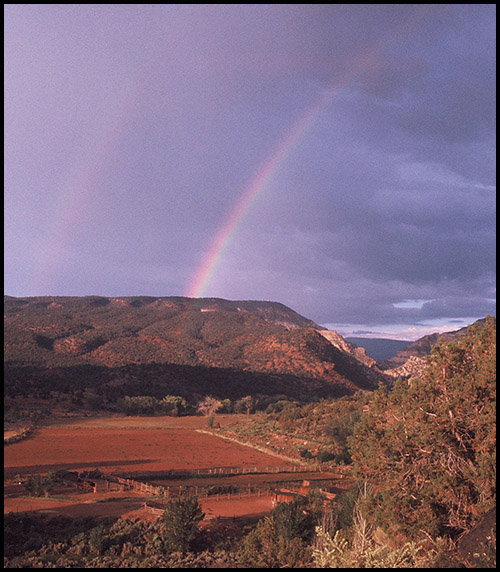 Pleasant Creek with a rainbow streaking across the sky.