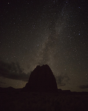 Brilliant night sky over a red rock butte