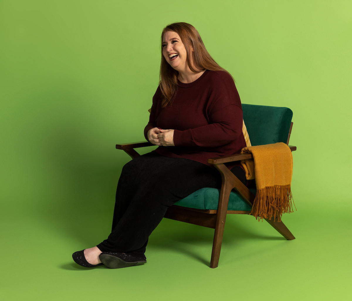Woman Laughing in a chair