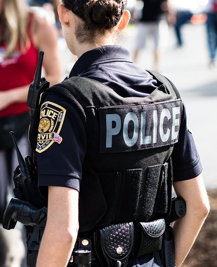 Police officer with her back to the camera