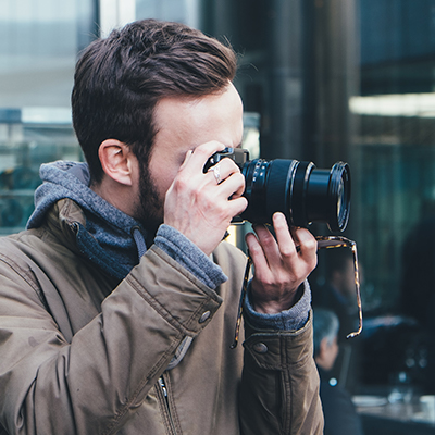 Detective taking surveillance photos