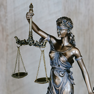 Bronze statue of Lady Justice with her blindfold, scale and sword