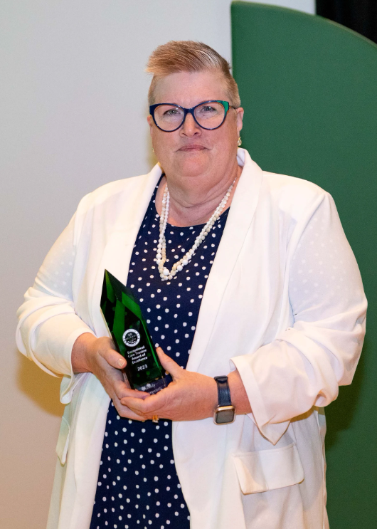 Woman holding a green award