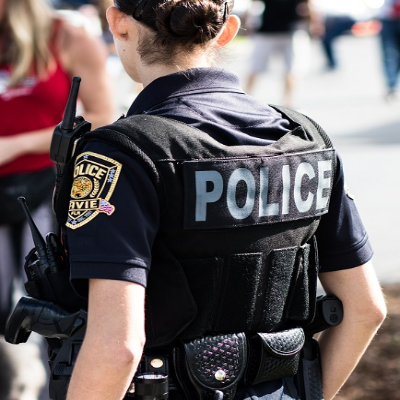 Police Officer with her back to the camera