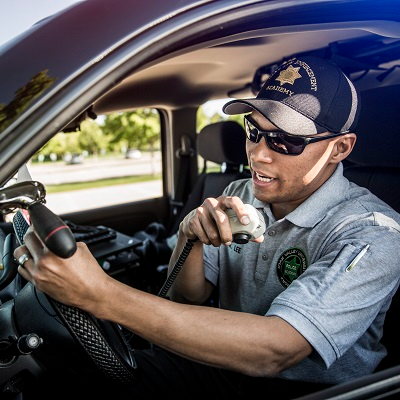 Police Officer sitting in his cruiser on the radio