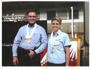 Man and woman with medals around their necks