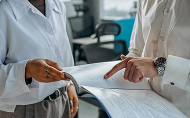 two people looking at a booklet