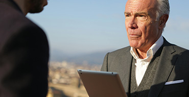 man in suit holding a clipboard