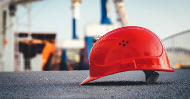 red hard hat on the asphalt