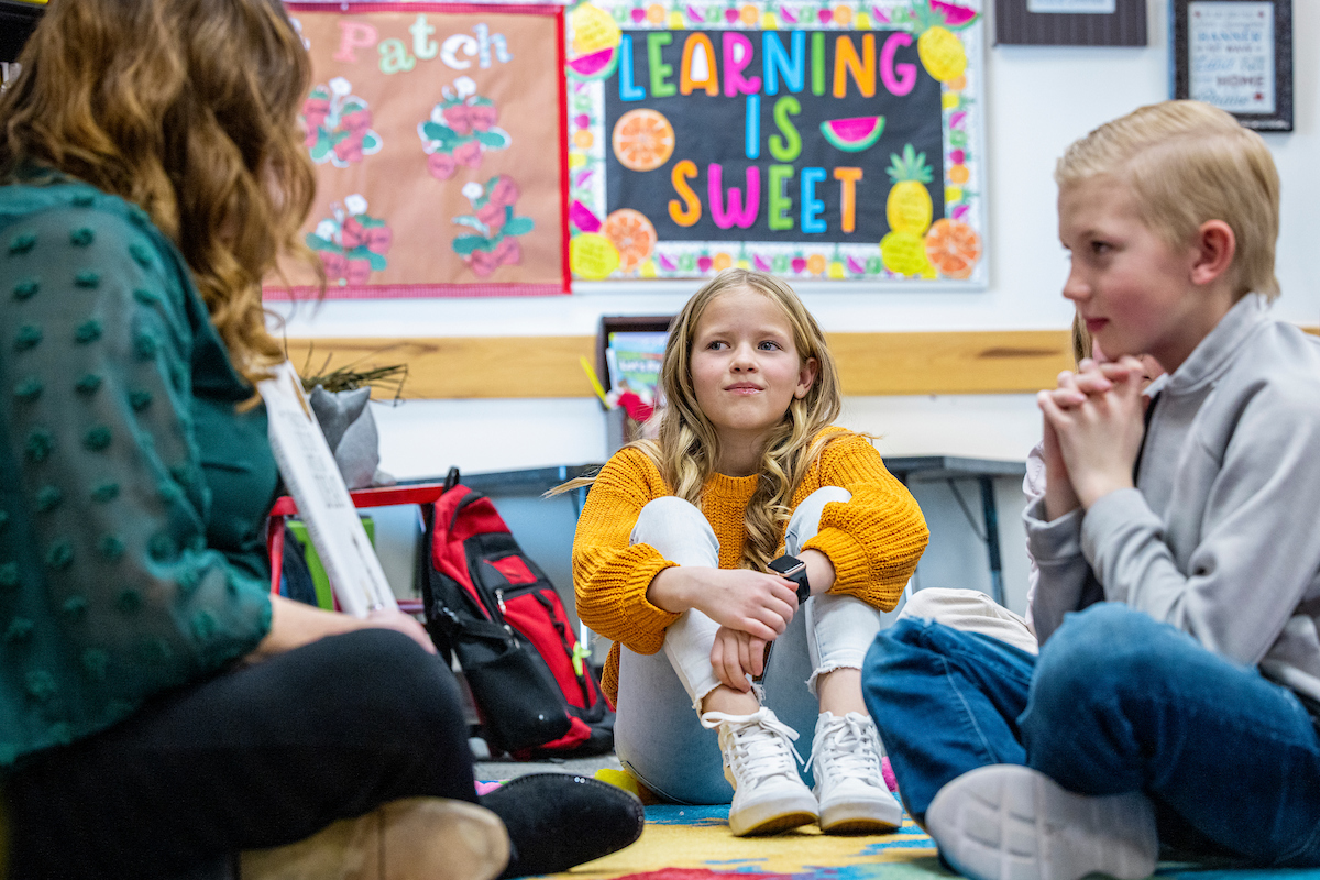 Image of elementary school teacher and students