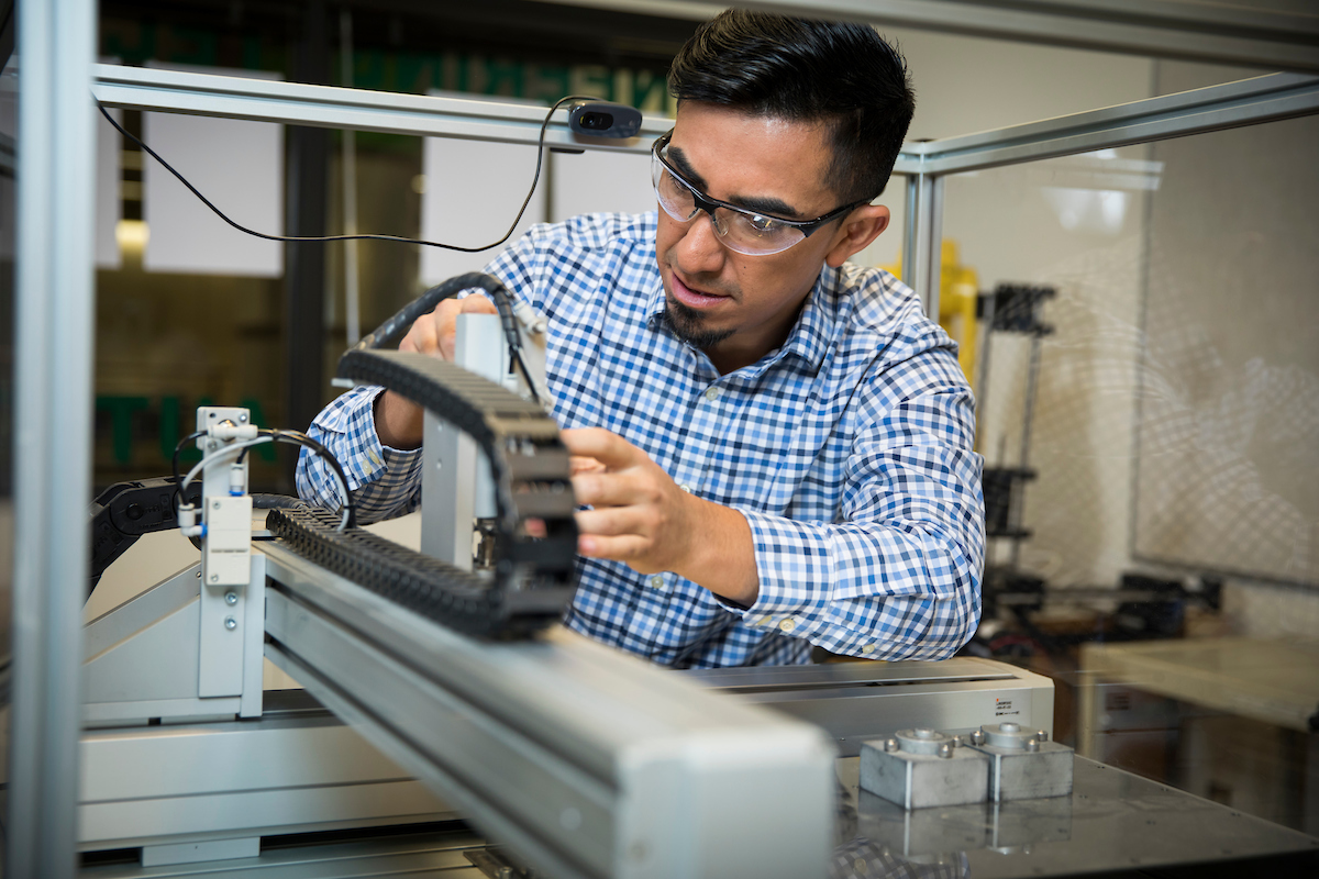 Image of someone working on a machine