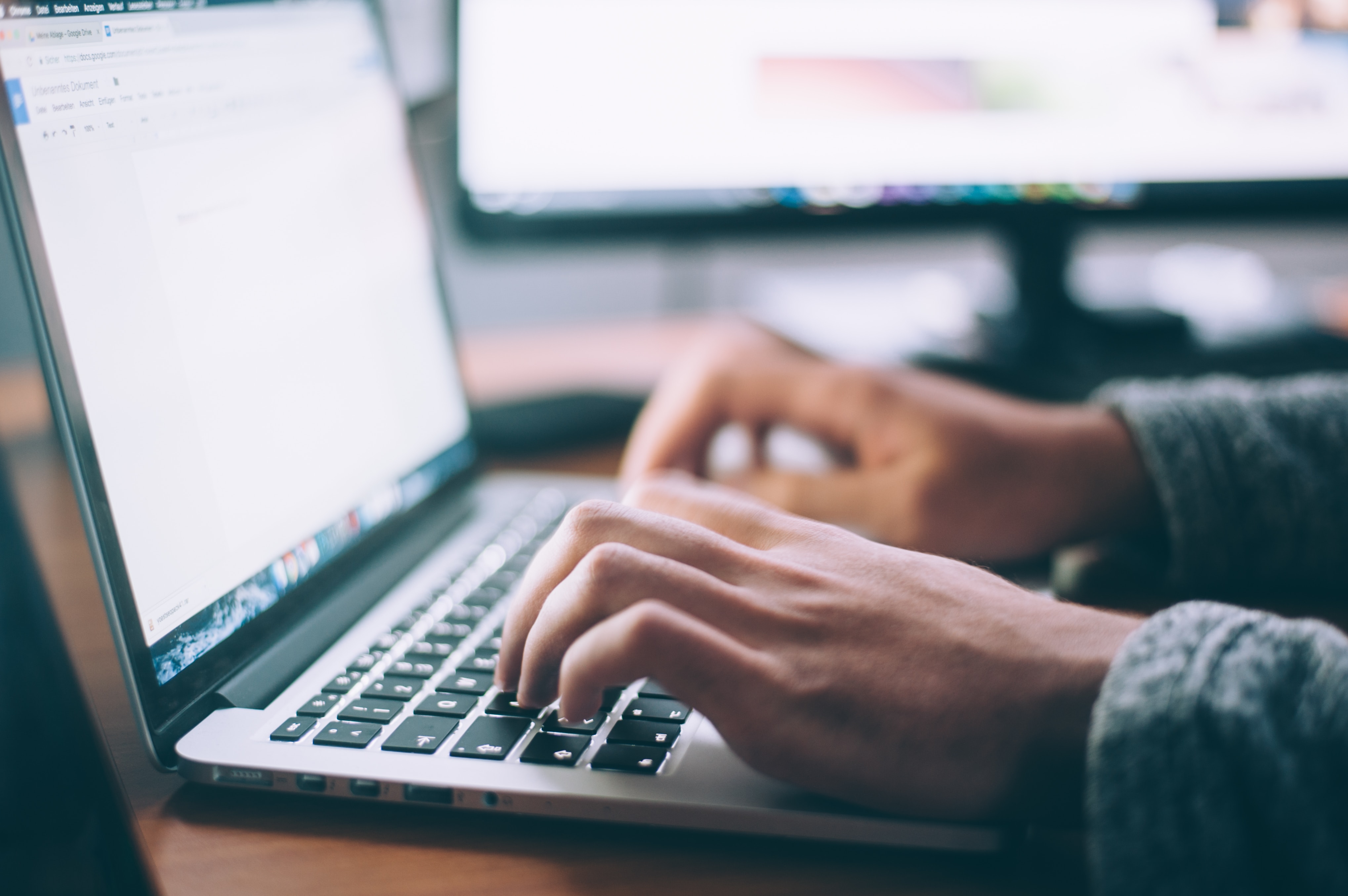 Image of someone typing on a laptop