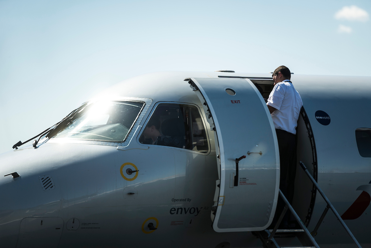 Image of a pilot getting on an airplane