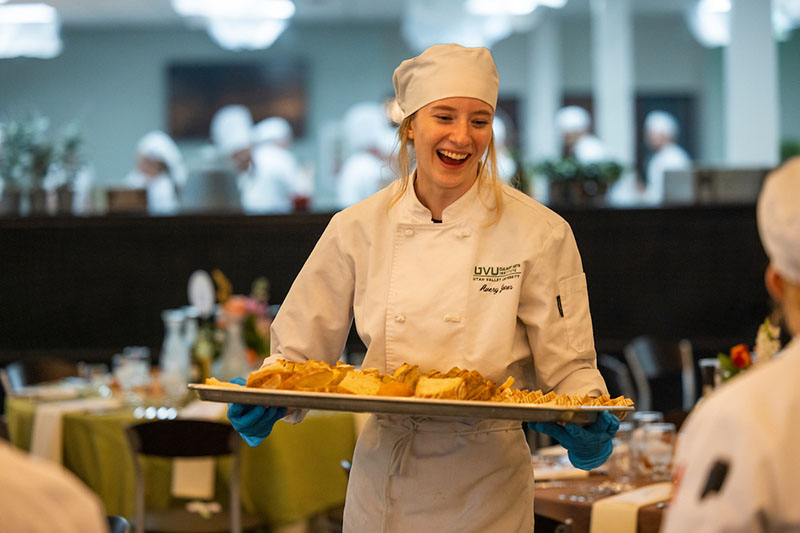 chef holding a tray of food