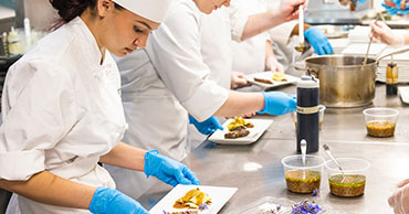 chef preparing a plate of food