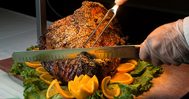 man carving meat