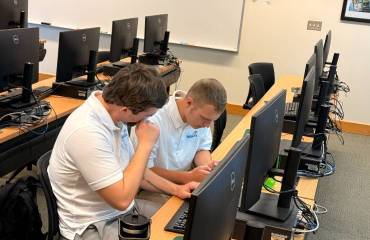 two members of Cybersecurity Club in computer lab