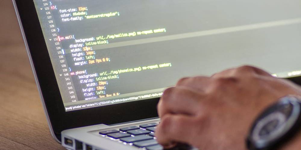 Close up of hand on laptop