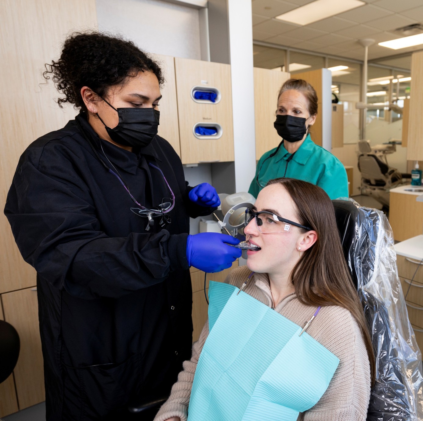 Dental Hygiene student with patient Dental Hygiene student with patient and instructor observing