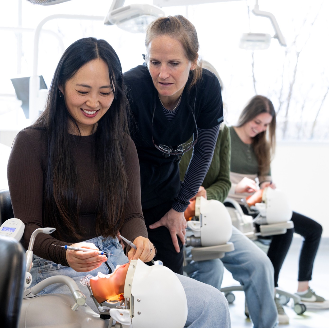 Dental Hygiene students in lab with instructor Dental Hygiene students in lab with instructor working on manikins