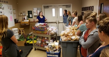 Dental Students standing in a Food and Care Coalition kitchen 