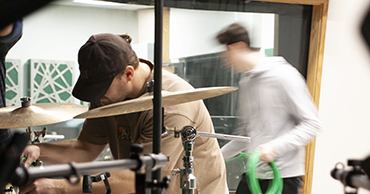 man using a drum set