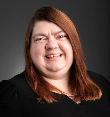 Photograph of Joyce Porter female wearing a black top and with long light brown hair