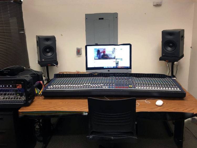 Audio mixing board with speakers and computer
