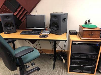 Computer on table with an audio rack to the side with restoration components