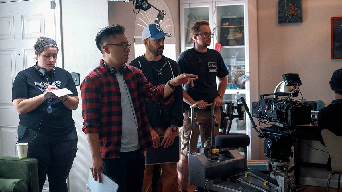 Jerell Rosales directing on set with three production crew members
