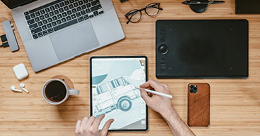 top view of a desk with a laptop and tablet