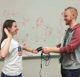 DAGA student president swearing in new leadership with game controller