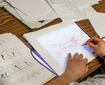 A Student sketching out a dog