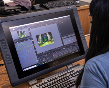 student creating a 3D animation on a computer