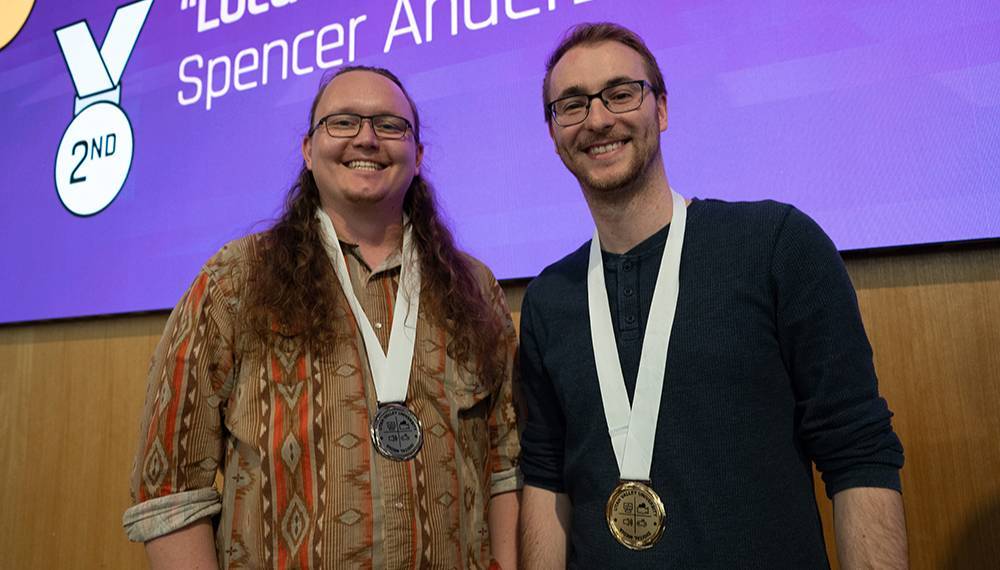 two stuents wearing medals