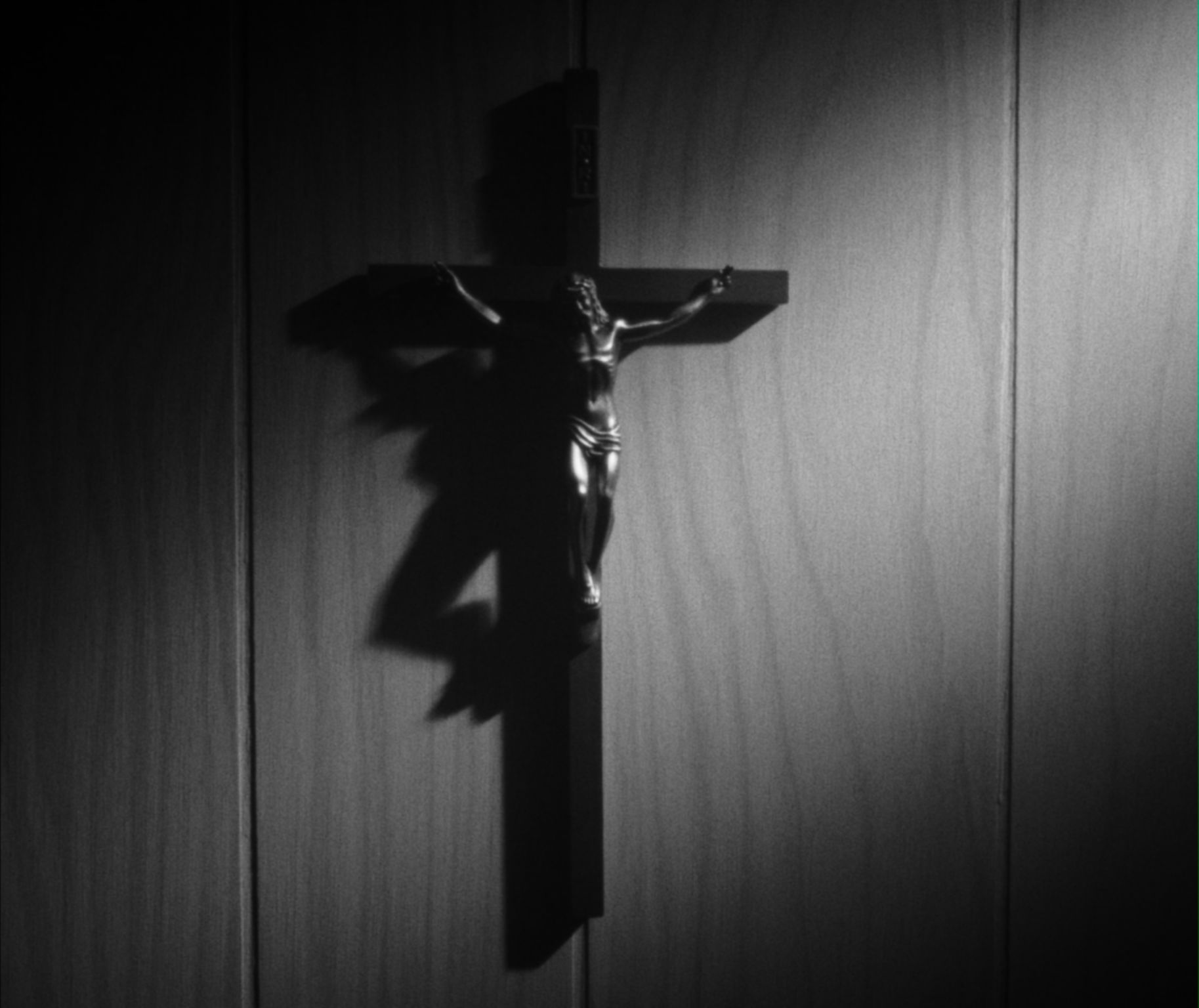 a closeup of a cross hanging on the wall