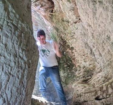 Man in a cave documenting Beit Lehi