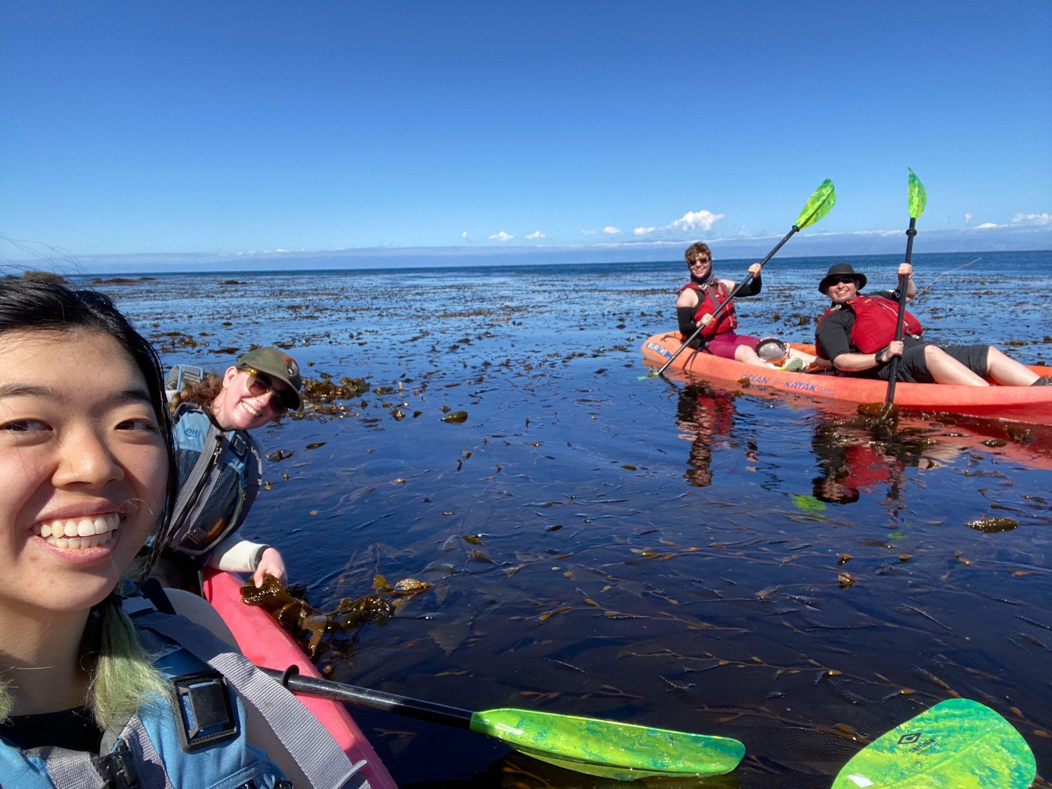 4 people on 2 red kayaks