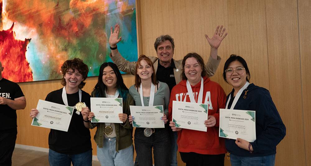 students wearing medals and holding certificates