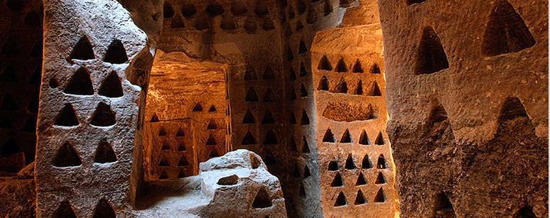 A Columbarium or dovecote with triangle shaped holes carved into the walls of a cave for turtle doves