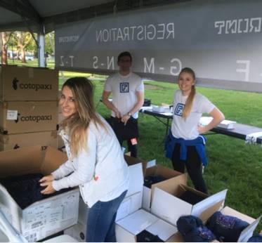 UVU Student Volunteers in tent handing out swag