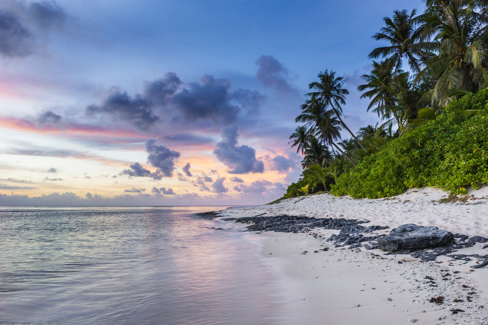 A picture of a beach at sunset.