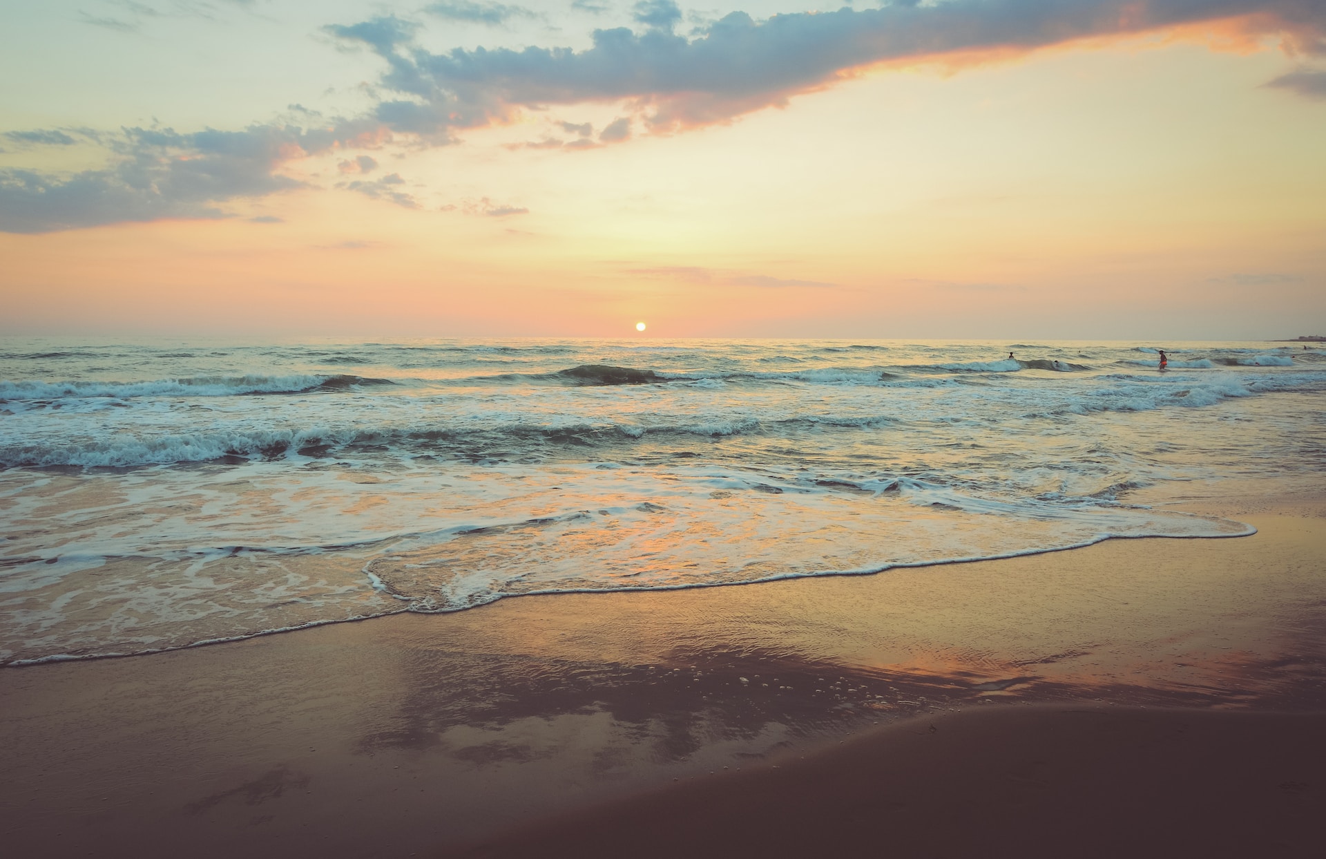 A picture of a beach at sunset.