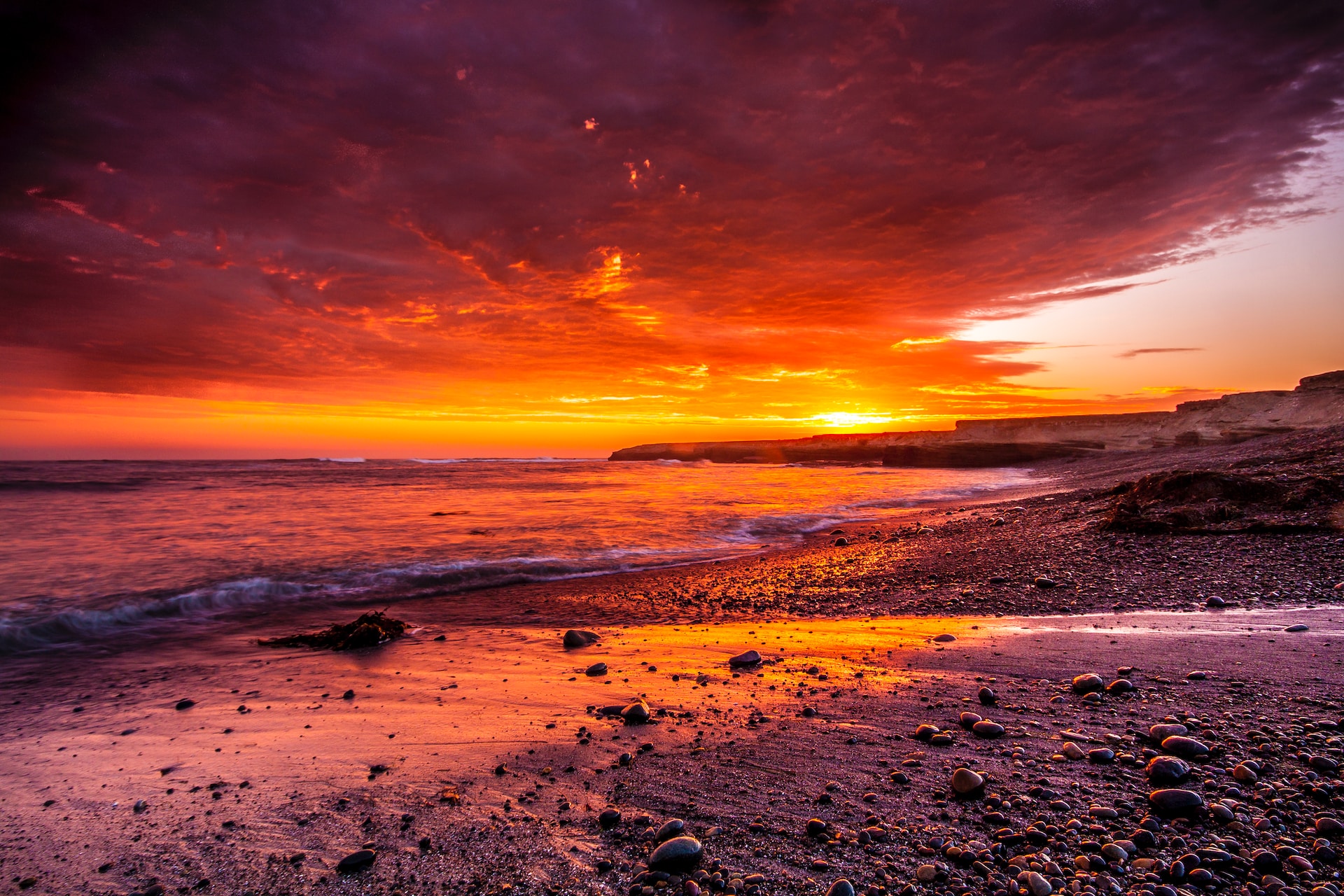 A picture of a beach at sunset.