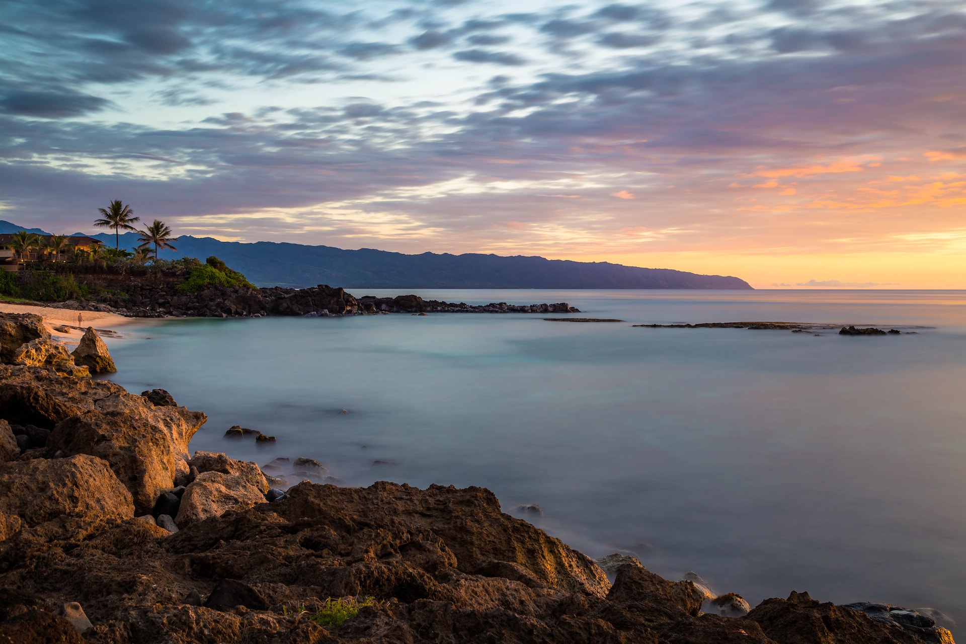 A picture of a beach at sunset.